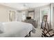 Bright bedroom featuring neutral walls, a gray dresser with mirror, and plush white bedding at 216 N Monroe St, Denver, CO 80206