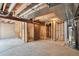 Unfinished basement with exposed ductwork and wood framing offers potential for customization and increased living space at 10836 W Evans Ave # 32, Lakewood, CO 80227
