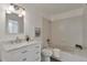 Bathroom featuring white vanity with marble countertop, tub, and tile surround at 10836 W Evans Ave # 32, Lakewood, CO 80227