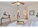 Comfortable bedroom featuring ceiling fan and ensuite bathroom access at 10836 W Evans Ave # 32, Lakewood, CO 80227