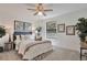 Cozy bedroom with ceiling fan, plush carpet, and decorative accents at 10836 W Evans Ave # 32, Lakewood, CO 80227