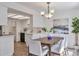 Bright dining area with modern lighting open to a nearby kitchen at 10836 W Evans Ave # 32, Lakewood, CO 80227