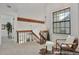 Hallway with wood railing, window seating area, and decorative beam at 10836 W Evans Ave # 32, Lakewood, CO 80227