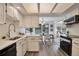 Bright and functional kitchen with stainless steel appliances, open to dining area at 10836 W Evans Ave # 32, Lakewood, CO 80227