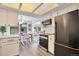 Well-lit kitchen with stainless steel appliances flows into dining area at 10836 W Evans Ave # 32, Lakewood, CO 80227