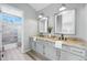 Bright bathroom with dual sinks, granite counters, and a separate walk-in shower at 2192 E Phillips Ln, Centennial, CO 80122