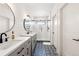 Charming bathroom with a dual vanity, a glass-enclosed shower and patterned tile flooring at 30796 Burland Rd, Golden, CO 80403