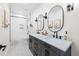 Modern bathroom featuring double sinks, oval mirrors, and a shower-tub combination with white subway tile at 30796 Burland Rd, Golden, CO 80403