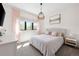Bright bedroom with a king-size bed, window, and mountain view at 30796 Burland Rd, Golden, CO 80403