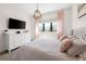 Inviting bedroom with a large window, modern lighting, and soft pink accents for a cozy ambiance at 30796 Burland Rd, Golden, CO 80403