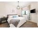 Bright bedroom with white walls, stylish light fixture, and floral curtains overlooking scenic views at 30796 Burland Rd, Golden, CO 80403