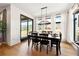 Bright dining room with a farmhouse table and access to backyard at 30796 Burland Rd, Golden, CO 80403