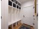 White entryway with built-in bench and storage at 30796 Burland Rd, Golden, CO 80403