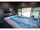 Luxurious hot tub room with a large sliding window offering serene outdoor views at 30796 Burland Rd, Golden, CO 80403