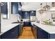 Modern kitchen with white quartz countertops and dark blue cabinetry at 30796 Burland Rd, Golden, CO 80403
