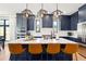 Modern kitchen with a large island, stainless steel appliances, and stylish pendant lighting at 30796 Burland Rd, Golden, CO 80403