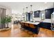 Open-concept kitchen with an island, modern lighting, and seamless transition to the dining area at 30796 Burland Rd, Golden, CO 80403