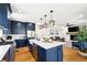 Open concept kitchen with a large island and stainless steel appliances at 30796 Burland Rd, Golden, CO 80403
