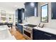 Close-up of a stylish kitchen with stainless steel appliances and a custom range hood at 30796 Burland Rd, Golden, CO 80403