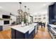Open concept kitchen with island, farmhouse sink, and hardwood floors at 30796 Burland Rd, Golden, CO 80403