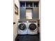 Laundry room with white washer and dryer and blue cabinets at 30796 Burland Rd, Golden, CO 80403