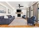 Bright living room featuring a fireplace, large windows, hardwood floors and comfortable seating at 30796 Burland Rd, Golden, CO 80403