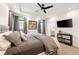 Cozy main bedroom with a tray ceiling, neutral decor, and an ensuite bathroom at 30796 Burland Rd, Golden, CO 80403