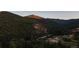 Scenic mountain view showcasing a property nestled among lush greenery and towering trees at 30796 Burland Rd, Golden, CO 80403
