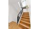 Elegant staircase featuring wood steps, black railings, and a modern design at 30796 Burland Rd, Golden, CO 80403