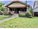 Charming brick home featuring a well-maintained lawn and classic architectural details at 2835 Cherry St, Denver, CO 80207