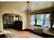Spacious living room showcasing hardwood floors, radiator, and chandelier at 2835 Cherry St, Denver, CO 80207