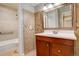 Updated bathroom featuring a vanity with a sink, mirror, and a tiled shower-tub combo at 3550 S Harlan St # 259, Denver, CO 80235