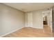 Bedroom with wood floors, neutral paint, and an open doorway with bathroom access at 3550 S Harlan St # 259, Denver, CO 80235