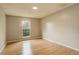 Bedroom with wood floors and a window looking out to the trees at 3550 S Harlan St # 259, Denver, CO 80235