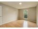 Bedroom with wood floors and a window providing natural light and a view of the trees at 3550 S Harlan St # 259, Denver, CO 80235