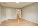 This is a bedroom with neutral walls and bright, natural light from the windows with hardwood floors at 3550 S Harlan St # 259, Denver, CO 80235