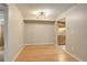 Bright dining room with wood floors, modern lighting, and an open view into the kitchen at 3550 S Harlan St # 259, Denver, CO 80235