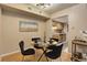 Dining area featuring a glass table, modern lighting, and adjacent kitchen space at 3550 S Harlan St # 259, Denver, CO 80235