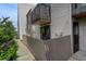 View of the exterior of the home featuring a private fenced patio and deck above at 3550 S Harlan St # 259, Denver, CO 80235