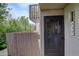 View of the front door and balcony on a two-story home with a wooden fence at 3550 S Harlan St # 259, Denver, CO 80235