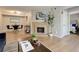 Bright living room with a tiled fireplace, dining area, modern lighting, and wood-look flooring at 3550 S Harlan St # 259, Denver, CO 80235