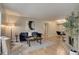 Inviting living room featuring a fireplace, wood floors, a blue sofa, and a dining space at 3550 S Harlan St # 259, Denver, CO 80235