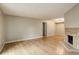 Bright living room with hardwood floors and a tile fireplace, offering a cozy ambiance at 3550 S Harlan St # 259, Denver, CO 80235