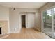 Living room featuring wood floors, fireplace, sliding glass door, and multiple access points at 3550 S Harlan St # 259, Denver, CO 80235