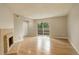 Spacious living room with a fireplace, wood floors, and a sliding glass door to the outside at 3550 S Harlan St # 259, Denver, CO 80235