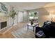 Cozy living room with a sliding glass door, fireplace, and neutral decor with a comfortable sofa at 3550 S Harlan St # 259, Denver, CO 80235