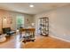 Bright home office featuring a desk, a window view, modern decor and wood floors at 3550 S Harlan St # 259, Denver, CO 80235