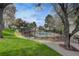 A view of the community pool surrounded by well-maintained grounds and greenery at 3550 S Harlan St # 259, Denver, CO 80235
