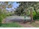 Outdoor community tennis court area surrounded by trees and greenery at 3550 S Harlan St # 259, Denver, CO 80235