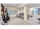 A finished basement with a sectional sofa, large world map and home gym equipment at 2163 S Grant St, Denver, CO 80210